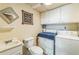 Functional bathroom and laundry room combination with washing machine, dryer, and ample cabinet space at 480 Pineburr Ln, Stone Mountain, GA 30087