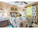 Inviting bedroom features a queen bed, ceiling fan, wood floor, and ample natural light at 480 Pineburr Ln, Stone Mountain, GA 30087