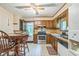 Cozy kitchen featuring wood cabinetry, stainless steel appliances, and a charming dining area at 480 Pineburr Ln, Stone Mountain, GA 30087
