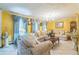 Bright living room with tile floors, yellow walls, curtains and comfortable seating for entertaining at 480 Pineburr Ln, Stone Mountain, GA 30087