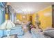 Elegant living room with patterned sofas, a chandelier, and bright yellow walls for a warm and inviting feel at 480 Pineburr Ln, Stone Mountain, GA 30087