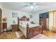 Comfortable main bedroom with wood floors, large bed, ceiling fan, and a television at 480 Pineburr Ln, Stone Mountain, GA 30087