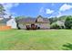 Back of the home with a wooden deck and spacious yard, great for outdoor living at 525 Hunnicutt Se Rd, Mableton, GA 30126