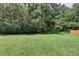 Expansive backyard featuring a lush lawn and mature trees for added privacy at 525 Hunnicutt Se Rd, Mableton, GA 30126