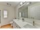 Bathroom featuring double sinks, large mirror, neutral tones, and modern finishes at 525 Hunnicutt Se Rd, Mableton, GA 30126