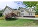 Inviting two-story home showcasing a lush green lawn, mature trees, and a serene setting at 525 Hunnicutt Se Rd, Mableton, GA 30126