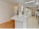 Bright kitchen features white cabinetry, stone countertops, tiled backsplash, and stainless steel appliances at 525 Hunnicutt Se Rd, Mableton, GA 30126