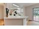 Well-lit kitchen featuring white cabinets, tile backsplash, stainless appliances, and a breakfast bar at 525 Hunnicutt Se Rd, Mableton, GA 30126