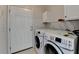 Convenient laundry room with modern washer and dryer units and exterior door at 525 Hunnicutt Se Rd, Mableton, GA 30126