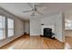 Inviting living room featuring hardwood floors, a fireplace, and natural light from windows at 525 Hunnicutt Se Rd, Mableton, GA 30126