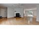 Open-concept living room with fireplace, hardwood floors, and easy access to the kitchen at 525 Hunnicutt Se Rd, Mableton, GA 30126