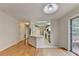 Bright living room with hardwood floors flowing into the kitchen with stainless steel appliances and a breakfast bar at 525 Hunnicutt Se Rd, Mableton, GA 30126