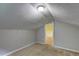 Cozy attic space features neutral carpet, a light fixture, and an open doorway at 165 Country Mill Ln, Stockbridge, GA 30281