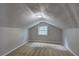 Cozy attic space with carpeted flooring and a window providing natural light at 165 Country Mill Ln, Stockbridge, GA 30281