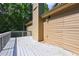 Spacious back deck adjacent to siding and a brick chimney, perfect for outdoor entertaining at 165 Country Mill Ln, Stockbridge, GA 30281