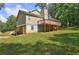 House back view displays a large deck, partially finished basement, and a lush green lawn at 165 Country Mill Ln, Stockbridge, GA 30281