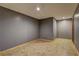 Neutral grey basement with tiled floors is ready for transformation into finished space at 165 Country Mill Ln, Stockbridge, GA 30281