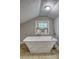 Charming bathroom with a standalone tub near a window with an air conditioner at 165 Country Mill Ln, Stockbridge, GA 30281