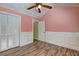 This bedroom features wood floors, paneled walls, closet and door at 165 Country Mill Ln, Stockbridge, GA 30281
