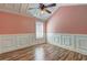Charming bedroom featuring wood floors, paneled walls, and a modern ceiling fan with lighting at 165 Country Mill Ln, Stockbridge, GA 30281