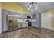 Modern kitchen features stainless steel appliances, stylish grey cabinetry, and an adjacent dining area at 165 Country Mill Ln, Stockbridge, GA 30281