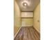 Laundry room featuring wood floors and white cabinets at 165 Country Mill Ln, Stockbridge, GA 30281