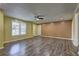 Spacious living room featuring wood floors, neutral walls, ceiling fan, and a bright window for natural light at 165 Country Mill Ln, Stockbridge, GA 30281