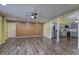 Bright living room featuring wood floors, neutral walls, ceiling fan, and an open layout that flows into the kitchen at 165 Country Mill Ln, Stockbridge, GA 30281