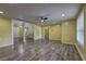 Spacious living room featuring hardwood floors, fan, and natural light at 165 Country Mill Ln, Stockbridge, GA 30281