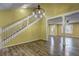 Sunlit living room featuring wood floors, a stairwell, and seamless transition to other rooms at 165 Country Mill Ln, Stockbridge, GA 30281