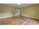 Open-concept living room featuring gleaming wood floors and neutral walls at 165 Country Mill Ln, Stockbridge, GA 30281