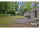 View of the backyard featuring a gravel patio and lush greenery at 2222 Beecher Sw Cir, Atlanta, GA 30311
