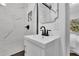 Modern bathroom features updated sink with white vanity and black hardware, along with marble backsplash at 2222 Beecher Sw Cir, Atlanta, GA 30311