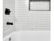 Close up of a tiled tub/shower with black trim and fixtures, plus a niche at 2222 Beecher Sw Cir, Atlanta, GA 30311