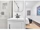 Stylish bathroom showcases marble tiled shower with black hardware and sink with black faucet at 2222 Beecher Sw Cir, Atlanta, GA 30311