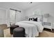 Comfortable main bedroom featuring a plush bed, slider barn door to bathroom and modern decor at 2222 Beecher Sw Cir, Atlanta, GA 30311