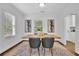 Bright dining room featuring a wood table, six chairs, and modern art at 2222 Beecher Sw Cir, Atlanta, GA 30311