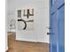 Bright entryway featuring hardwood floors, a blue front door, and stylish decor setting a welcoming tone at 2222 Beecher Sw Cir, Atlanta, GA 30311