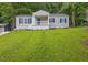 Charming home featuring a well-maintained lawn, blue shutters, and a cozy front porch perfect for enjoying the outdoors at 2222 Beecher Sw Cir, Atlanta, GA 30311