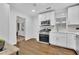 Modern kitchen featuring white cabinets, stainless steel appliances, and wood floors at 2222 Beecher Sw Cir, Atlanta, GA 30311