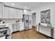 Updated kitchen showcasing stainless appliances, white cabinets, and hardwood floors at 2222 Beecher Sw Cir, Atlanta, GA 30311