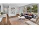 Spacious living room featuring hardwood floors, modern decor, and large windows providing plenty of natural light at 2222 Beecher Sw Cir, Atlanta, GA 30311