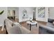 Well-appointed living room showcasing stylish furnishings, hardwood floors, and a seamless flow to the adjacent dining area at 2222 Beecher Sw Cir, Atlanta, GA 30311