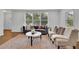 Cozy living room with a plush sofa, stylish armchairs, and a decorative area rug creating a comfortable atmosphere at 2222 Beecher Sw Cir, Atlanta, GA 30311