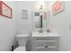 Bathroom featuring white walls, vanity with a sink, and decorative wall art at 6744 Rockbridge Rd, Stone Mountain, GA 30087