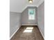 Attic bedroom featuring neutral walls, carpet flooring, and natural light at 6744 Rockbridge Rd, Stone Mountain, GA 30087