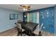 Charming dining area featuring a modern light fixture, and stylish decor creating an inviting space at 6744 Rockbridge Rd, Stone Mountain, GA 30087