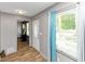 Inviting entryway with a front door, wood-look flooring, and abundant natural light at 6744 Rockbridge Rd, Stone Mountain, GA 30087