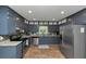 Well-equipped kitchen featuring stainless steel appliances, stylish cabinets, and granite countertops at 6744 Rockbridge Rd, Stone Mountain, GA 30087