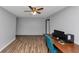 Spacious living room with wood floors and a blue chair at 6744 Rockbridge Rd, Stone Mountain, GA 30087
